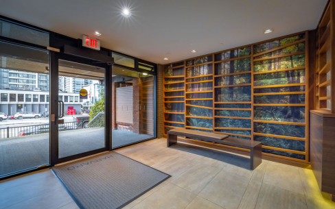 Front lobby interior of the Harvard facing St. Georges Avenue. The lobby has a unique wood paneling art feature