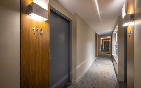 Harvard Apartments common area hallway with unit 110 being featured